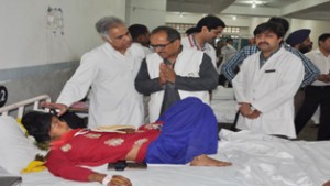 Dy Chief Minister, Dr Nirmal Singh interacting with an accident victim at GMC on Tuesday.