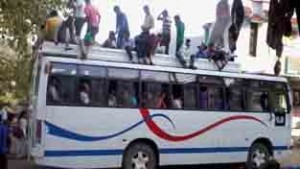 An overloaded bus with passengers roof top plying on Mahanpur-Basohli road on Tuesday. —Excelsior/Madan