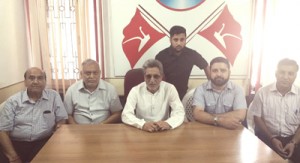 Senior NC leader and former Minister, Mushtaq Ahmed Bukhari along with other party leaders addressing media                 persons at Jammu.