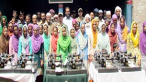 Women posing with sewing machines provided by Army in Village Kotli of Rajouri district.