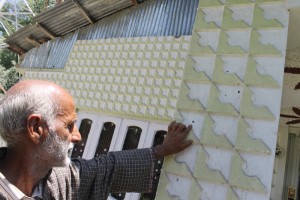 A man shows bullet mark at the house of PDP leader in Wachi on Thursday. —Excelsior/Younis Khaliq
