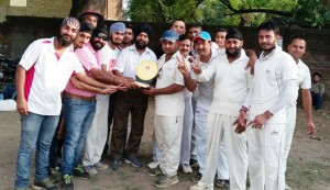 Dignitory presenting a trophy to ESCC team on winning a league match on Thursday.