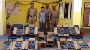 Seized liquor and bootlegger in police custody at Katra.