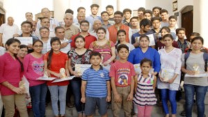 Students who were given away prizes by KPS Jammu posing for a photograph with MLC and  Sabha members at Jammu on Saturday. —Excelsior/Rakesh