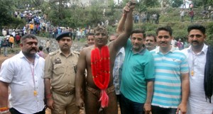 Wrestler Lallu posing for photograph with dignitaries after clinching Chamba Dangal title.