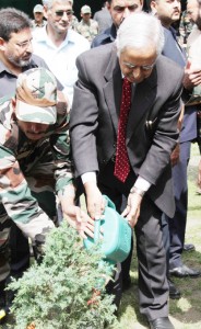 Chief Minister Mufti Mohd Sayeed planting deodar sapling at Baltal on Monday.