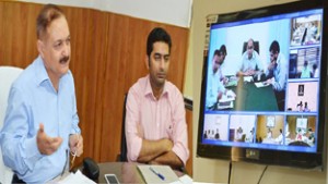 Divisional Commissioner Dr Pawan Kotwal reviewing implementation of Swachh Vidyalaya programme through video conferencing with DCs.