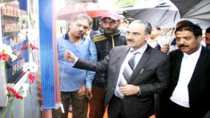 Justice Ali Mohammad Magrey inaugurating ATM Booth at District Court Complex Budgam on Wednesday.