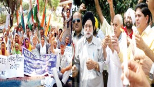 A group of PoJK refugees staging dharna at Press Club and SOS International activists taking out candle march in Jammu. -Excelsior/Rakesh