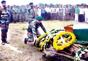 Wreaths being laid over the body of martyr Rifleman by Deputy GOC at village Gora Brahmana Akhnoor on Tuesday.