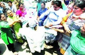 Mahila Congress workers burning effigies of Narendra Modi and Sushma Swaraj during  protest in Jammu on Thursday.  -Excelsior/Rakesh