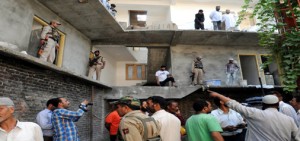 Security personnel stand guard at a building where militants lobbed grenade in Srinagar on Friday. -Excelsior/Amin War