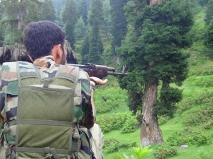 A security personnel takes position during encounter with militants at Shopian on Saturday. -Excelsior/Younis Khaliq