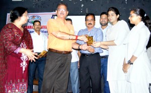 Speaker Kavinder Gupta felicitating winners of quiz competition organized by Jammu Municipal Corporation on Monday.