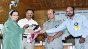KUTA felicitating a teacher during annual day function on Saturday.