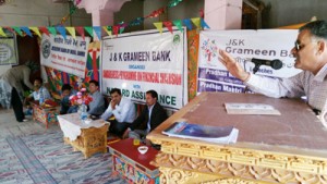 J&K Grameen Bank functionary apprising about various social security schemes during a camp at Leh.