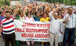 FMPHWs staging protest outside Directorate of Health Services in Jammu on Tuesday. —Excelsior/Rakesh