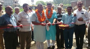 Minister for Industries Chander Parkash Ganga flanked by MP, Jugal Kishore Sharma laying foundation stone of a development work in Bari Brahmana on Sunday.