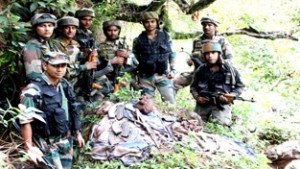 Army jawans pose with arms and ammunition at Lal Thandapani forests in Kalakote on Friday.