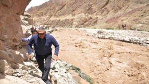 Minister for Cooperative Chhering Dorjey crossing badly damaged Chalung area on Friday.