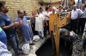 DyCM Dr Nirmal Singh inspecting damages caused by floods. 
