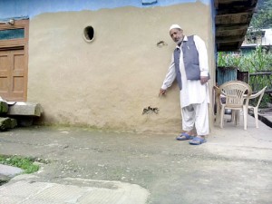 A civilian shows bullet marks on his house at Sabzian in Poonch on Thursday. —Excelsior/Harbhajan