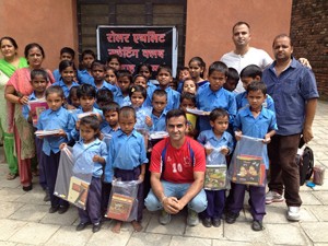 Students of Govt Primary School Peer Kho posing for a group photograph after receiving stationery items from Jindrah Club in Jammu.
