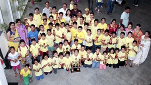 Children posing for a group photograph alongwith the chief guest and other dignitaries during Prize Distribution Function organized by Ucmas Abacus in Jammu.