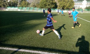Footballer taking long strides while trying to get hold of the ball during a match of Khyber Super Division Big Premier League at Srinagar on Saturday.