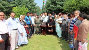 Valsa Purushotam, wife of Late Maj Purushotam, flanked by GOC 15 Crops Subrata Saha, presenting trophy to Army Good Will School during function at Srinagar.