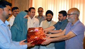 Minister for Education, Naeem Akhtar felicitating 10th class topper Anika in Srinagar on Friday.