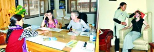 Foreign tourists being guided by an employee at Tourist Information Centre, Leh (L) and a tourist receiving benefit of oxygen bar (R).