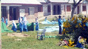 Students cleaning mats in GMS Wapora.