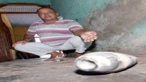 An ex-serviceman shows live mortar shell in his house at Abdullian in R S Pura sector on Friday. -Excelsior/ Rakesh