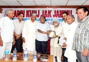 A literary personality being felicitated by Adbi Kunj during its Foundation Day function at Jammu on Sunday. -Excelsior/Rakesh