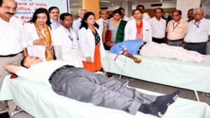 Divisional Commissioner, Dr Pawan Kotwal and Regional Director, RBI, D Sethy donating blood at a camp on Thursday.