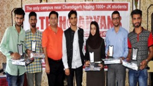Aryans’ Kashmiri students who shines in PTU merit list posing for a photograph with Dr Anshu Kataria, chairman, Aryans Group of Colleges, at Srinagar.