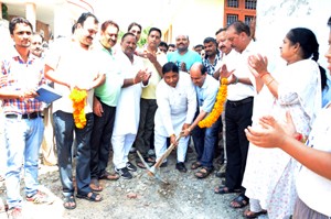MLA Jammu West, Sat Sharma digging ground to start work of lane in Janipur on Sunday.