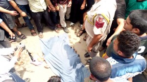 Body of accident victim kept on road by agitating people at Dhar road in Udhampur on Monday.