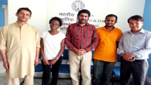 Four international scholars posing with Regional Director ICCR Jammu, Balwant Thakur at ICCR headquarters.