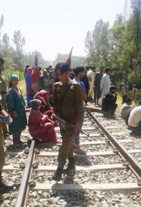 People blocking Banihal-Baramulla Railway track at Wanduna Sangam. -Excelsior/Younis Khaliq