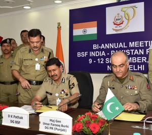 DG BSF D K Pathak and DG Rangers (Punjab) Umar Farooq Burki signing declaration in New Delhi on Saturday.
