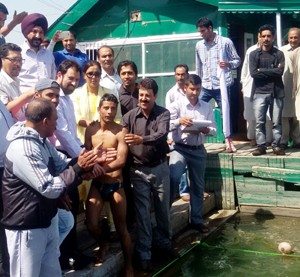 DG Sports, Jahangir Mir and other dignitaries during inaugural ceremony of water sports activities in Srinagar on Monday.