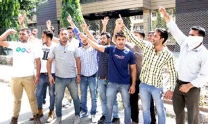 Power lifters raising slogans while protesting at J&K State Sports Council Office, MA Stadium in Jammu. -Excelsior/Rakesh