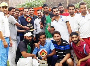 Winners Khalsa Cricket Club players posing for a group photograph at Ramnagar in Udhampur. 