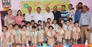 Winners of story telling and poem recitation competition posing for a group photograph along with chief guest Yudhvir Sethi, senior BJP Leader.