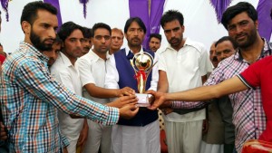 Trophy being unveiled by PCC Chief, GA Mir while inaugurating Inter District Cricket Tournament at Dooru in Anantnag.