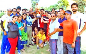 Winners of Basketball Tournament receiving trophy by Principal, Amarendra Kumar Mishra  while posing for a group photograph at KC Public School in Jammu.