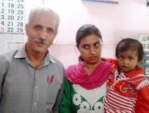 Abandoned female baby with officials of Child-Line.