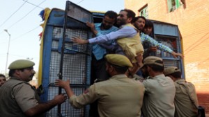 Policemen detaining members of fair price shops run by the Cooperative Department during a protest  against State Government in Srinagar on Thursday. -Excelsior/Amin War